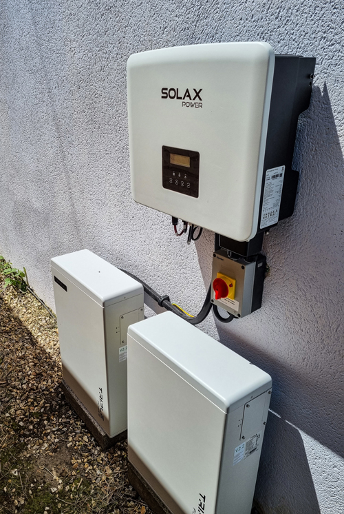 Solax Solar PV battery storage battery and inverter wall mounted outside storing renewable energy